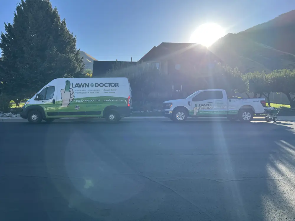 Lawn Doctor van and truck on a local street